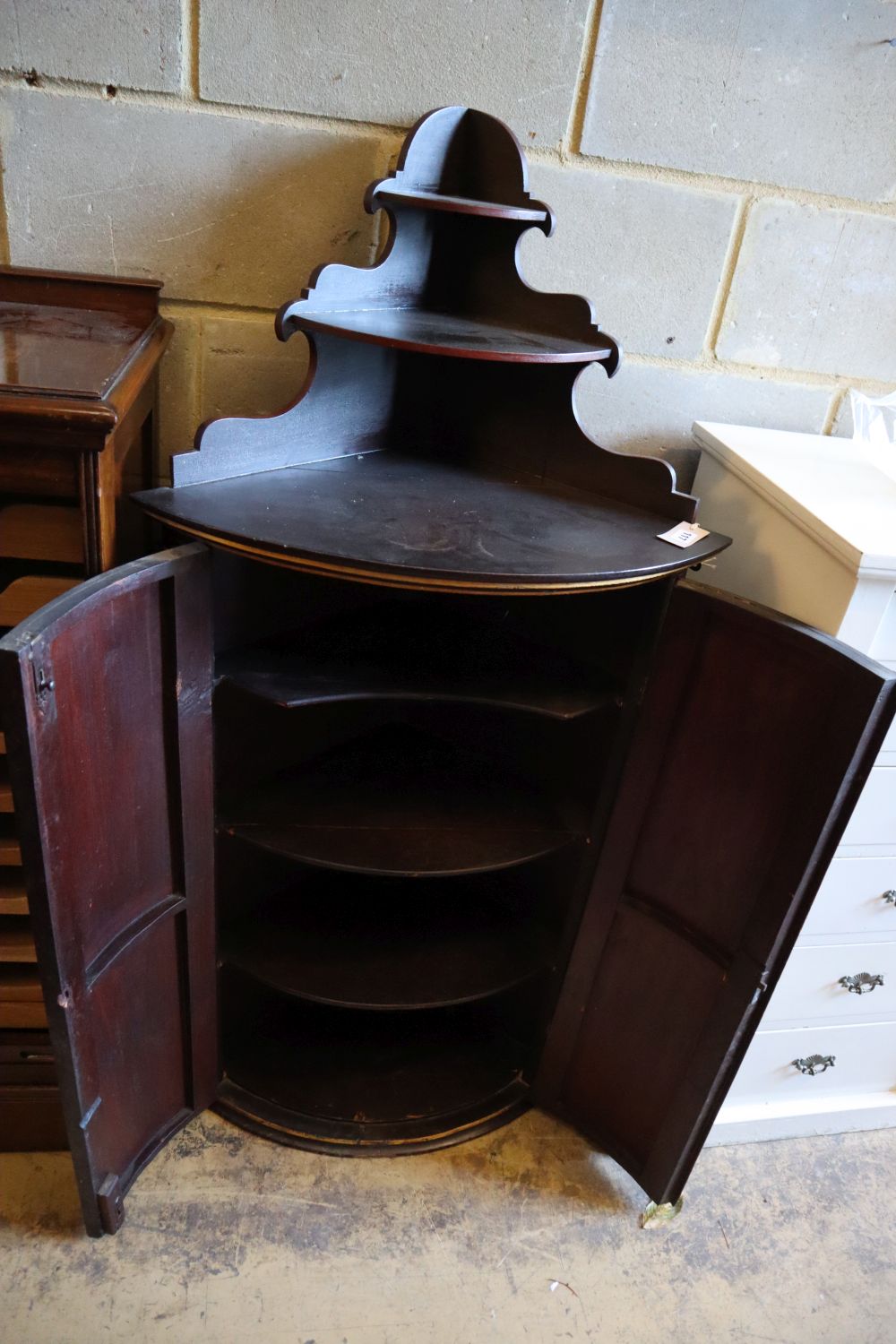 A Dutch painted and gilded hanging corner cupboard, circa 1800, width 57cm, depth 42cm, height 140cm